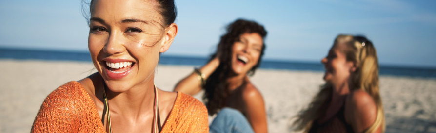 women smiling on beach
